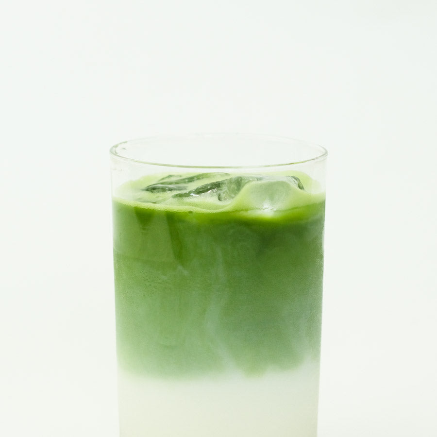 A creamy matcha latte made with Jeju Matcha, presented in a glass cup.