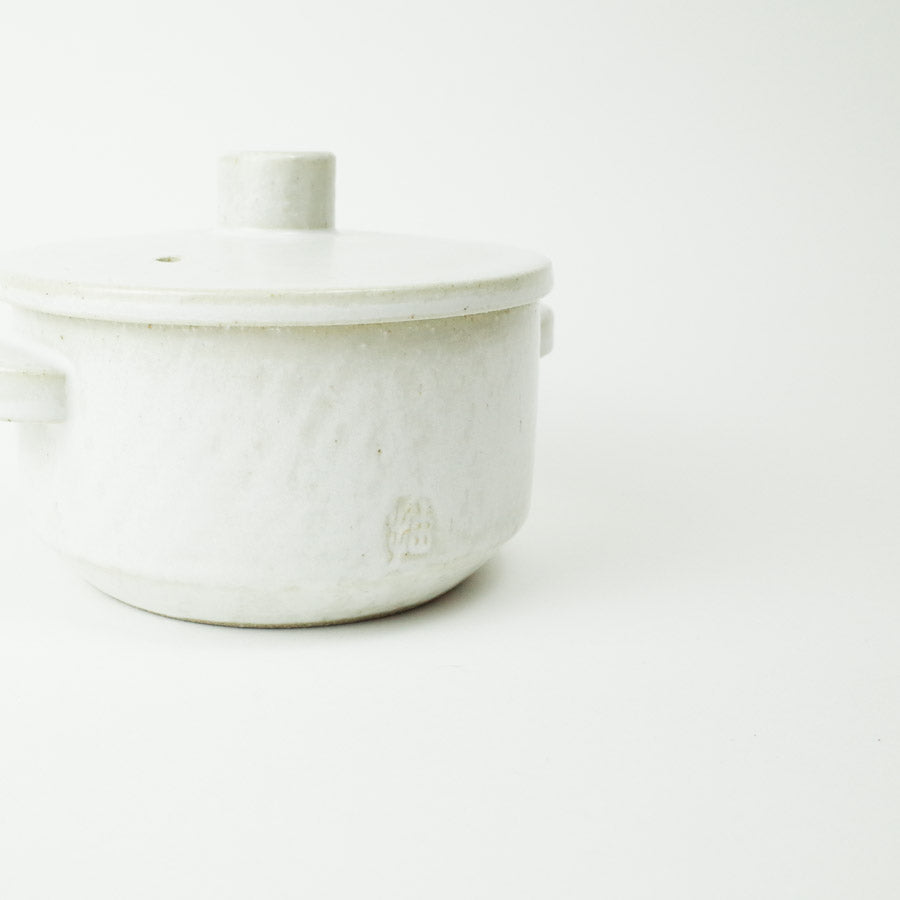 lose-up of the handcrafted details on the MIM Baekwoon ceramic pot.